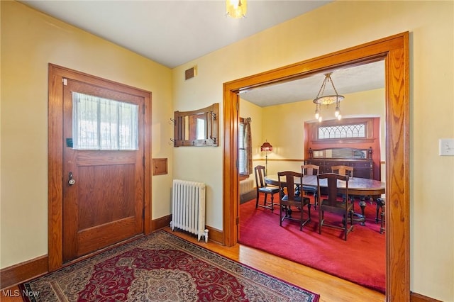 97 Overlook Blvd, Struthers, OH 44471 - entrance foyer with radiator, wood finished floors, and baseboards