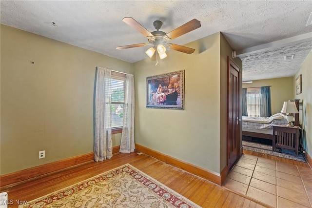 97 Overlook Blvd, Struthers, OH 44471 - unfurnished room featuring baseboards, a textured ceiling, plenty of natural light, and wood finished floors