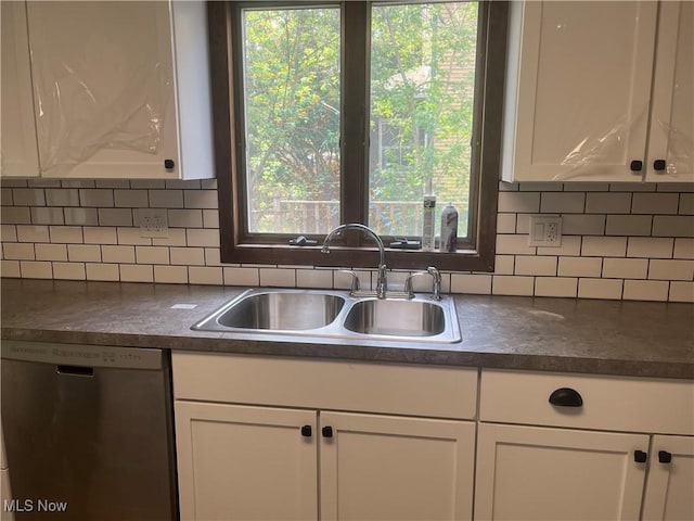 533 W Park Ave, Niles, OH 44446 - kitchen with dishwasher, a sink, dark countertops, white cabinetry, and backsplash