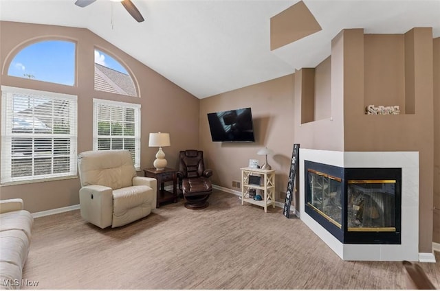 4044 Saint Andrews Ct, Canfield, OH 44406 - living room featuring lofted ceiling, baseboards, ceiling fan, a multi sided fireplace, and wood finished floors