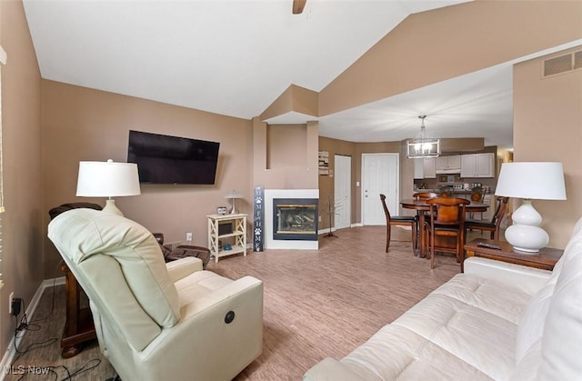 4044 Saint Andrews Ct, Canfield, OH 44406 - living room with baseboards, a glass covered fireplace, high vaulted ceiling, and a chandelier