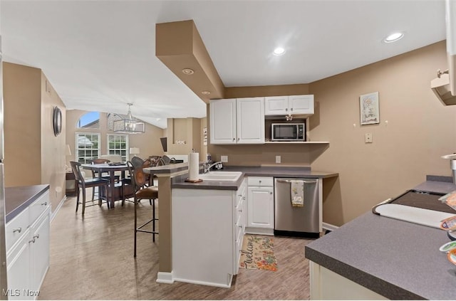 4044 Saint Andrews Ct, Canfield, OH 44406 - kitchen with appliances with stainless steel finishes, dark countertops, a sink, white cabinets, and recessed lighting