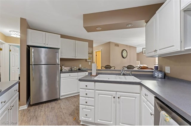 4044 Saint Andrews Ct, Canfield, OH 44406 - kitchen with appliances with stainless steel finishes, a sink, light wood-style flooring, and white cabinets