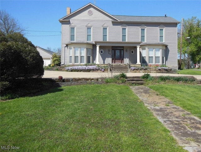 518 Hill St, Coshocton, OH 43812 - view of front of house featuring a front yard and a chimney