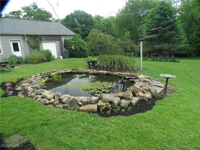 518 Hill St, Coshocton, OH 43812 - view of green lawn with a garden pond