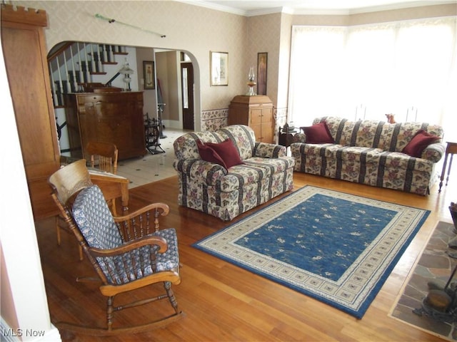 518 Hill St, Coshocton, OH 43812 - living room with wallpapered walls, arched walkways, crown molding, stairway, and wood finished floors