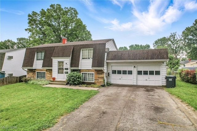 4438-4440 Washington Square Dr, Austintown, OH 44515 - colonial inspired home featuring a gambrel roof, stone siding, asphalt driveway, an attached garage, and a shingled roof