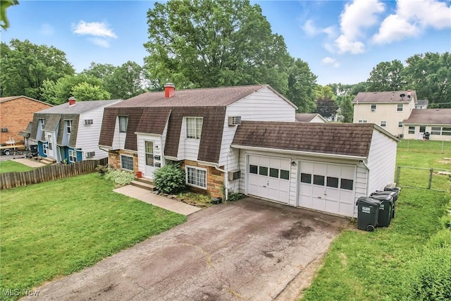 4438-4440 Washington Square Dr, Austintown, OH 44515 - view of front of property with a gambrel roof, roof with shingles, a garage, driveway, and a chimney
