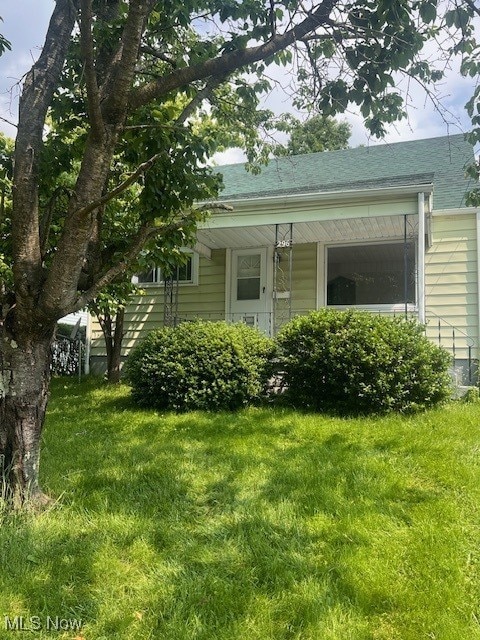 296 Sanderson Ave, Campbell, OH 44405 - view of side of home with a lawn and a shingled roof