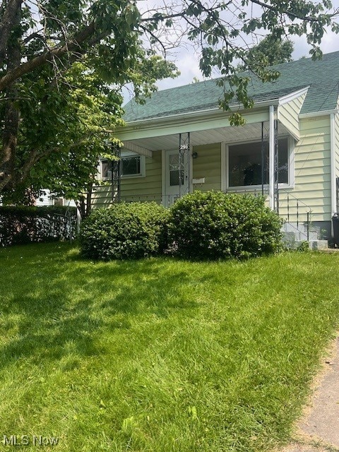 296 Sanderson Ave, Campbell, OH 44405 - view of front facade with a front yard, roof with shingles, and covered porch