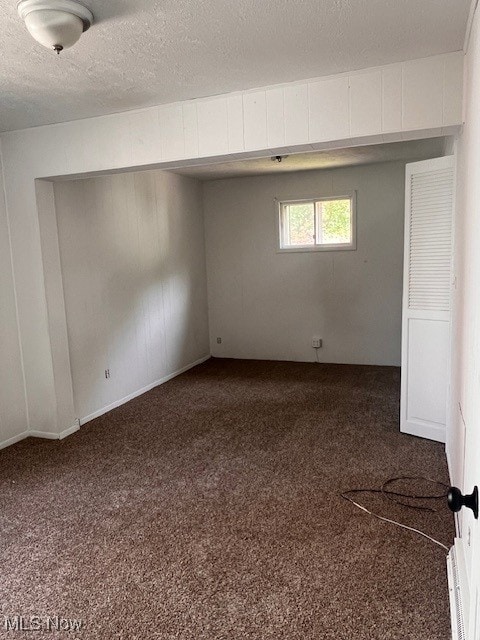 296 Sanderson Ave, Campbell, OH 44405 - spare room featuring dark carpet and a textured ceiling