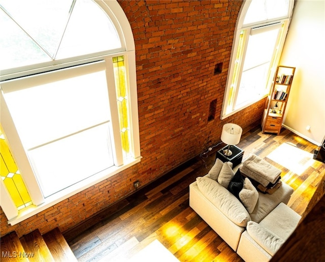 2337 W 11th St Unit 6, Cleveland, OH 44113 - living room with brick wall, wood finished floors, and arched walkways