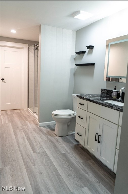 2337 W 11th St Unit 6, Cleveland, OH 44113 - bathroom with wood finished floors, vanity, toilet, a stall shower, and recessed lighting