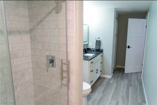 2337 W 11th St Unit 6, Cleveland, OH 44113 - full bath with toilet, vanity, wood finished floors, a tile shower, and baseboards