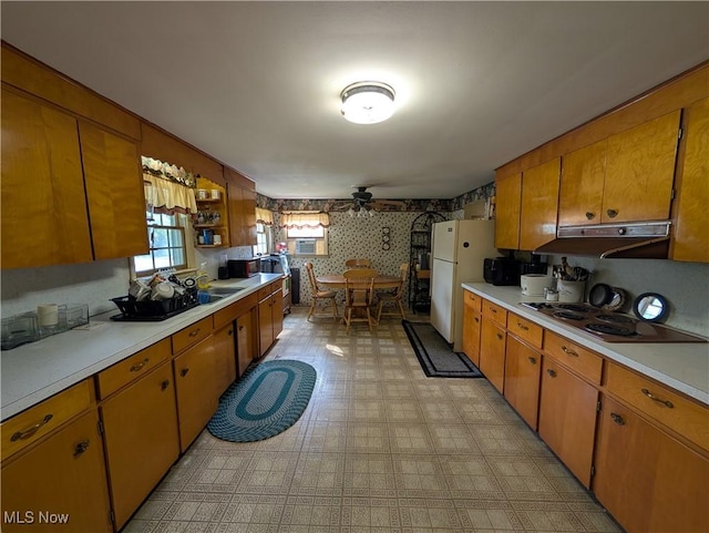 5710 Sugargrove Rd, Blue Rock, OH 43720 - kitchen featuring electric stovetop, freestanding refrigerator, light countertops, under cabinet range hood, and wallpapered walls