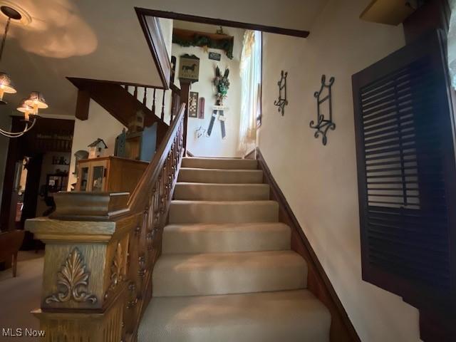 705 Main St, Toronto, OH 43964 - stairs with a chandelier