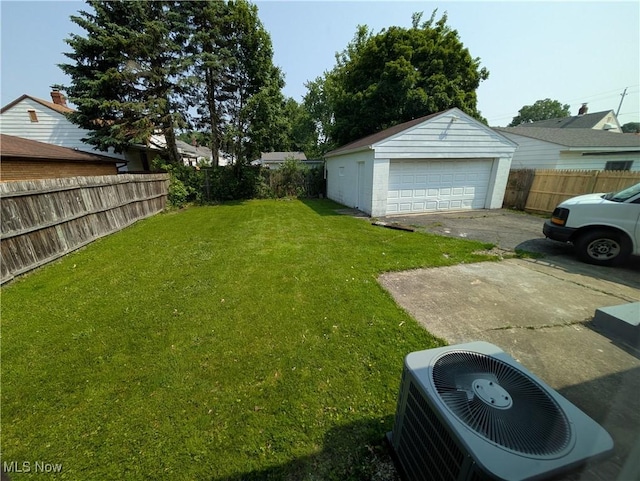727 N Firestone Blvd, Akron, OH 44306 - view of yard featuring central air condition unit, an outbuilding, and a garage