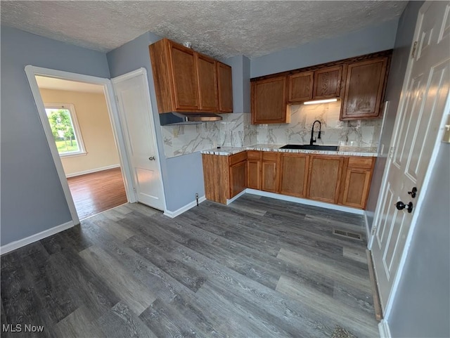 727 N Firestone Blvd, Akron, OH 44306 - kitchen with a sink, dark wood-type flooring, tasteful backsplash, light countertops, and brown cabinetry