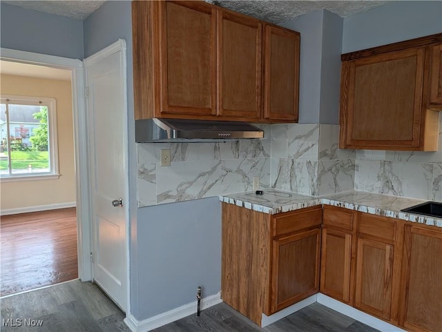 727 N Firestone Blvd, Akron, OH 44306 - kitchen with dark wood-style floors, light countertops, range hood, brown cabinetry, and a textured ceiling