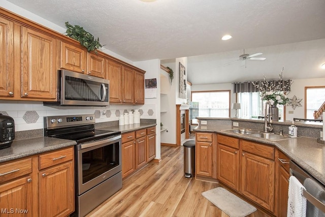 2401 Bunker Ln Unit B, Willoughby, OH 44094 - kitchen with appliances with stainless steel finishes, light wood finished floors, brown cabinetry, and recessed lighting