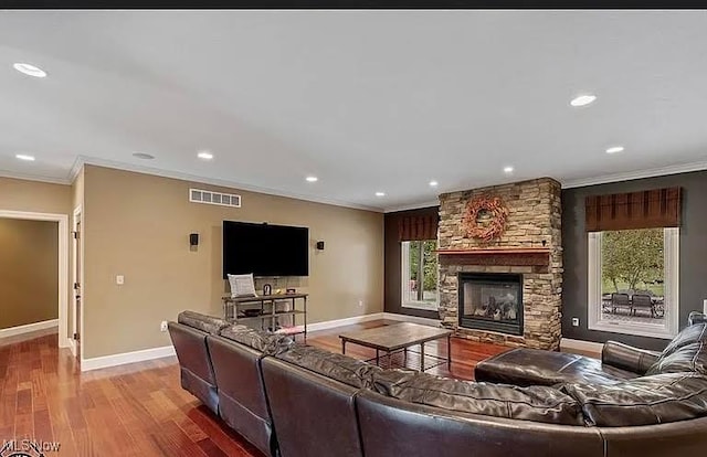 8320 Westfield Rd, Seville, OH 44273 - living area featuring ornamental molding, baseboards, wood finished floors, a fireplace, and recessed lighting