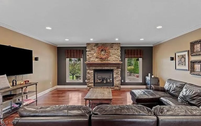 8320 Westfield Rd, Seville, OH 44273 - living area with healthy amount of natural light, ornamental molding, wood finished floors, baseboards, and a stone fireplace