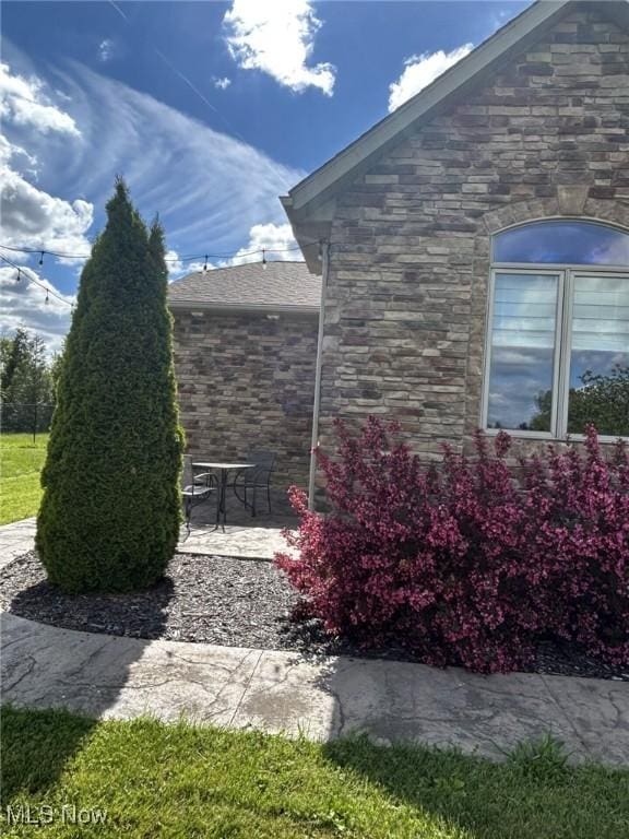 8320 Westfield Rd, Seville, OH 44273 - view of side of home with a patio and stone siding