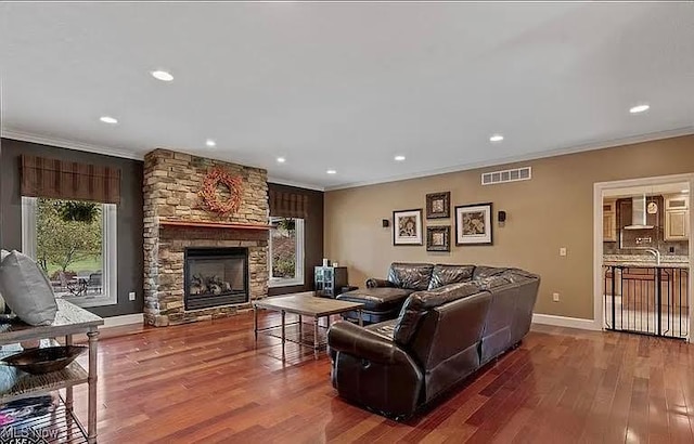 8320 Westfield Rd, Seville, OH 44273 - living area with a fireplace, ornamental molding, wood finished floors, recessed lighting, and baseboards