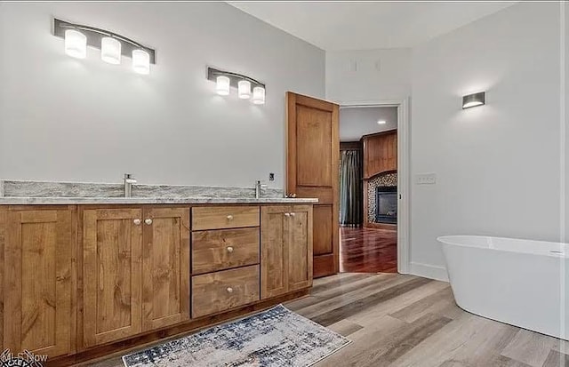 8320 Westfield Rd, Seville, OH 44273 - bathroom featuring a soaking tub, wood finished floors, and double vanity