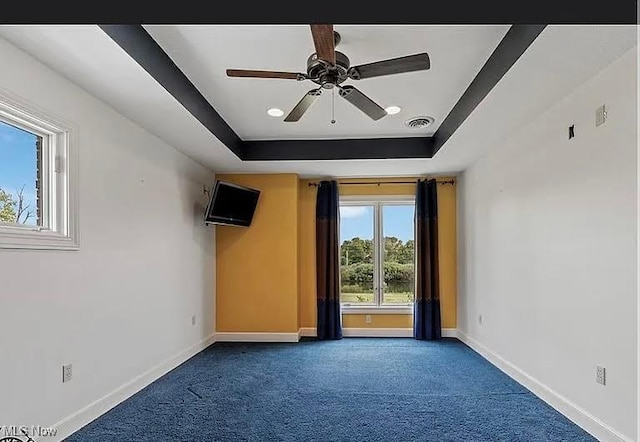 8320 Westfield Rd, Seville, OH 44273 - carpeted spare room featuring baseboards, a raised ceiling, and a ceiling fan