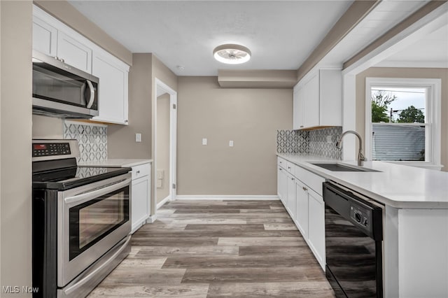 20980 Ball Ave, Euclid, OH 44123 - kitchen featuring stainless steel appliances, a sink, decorative backsplash, and light countertops