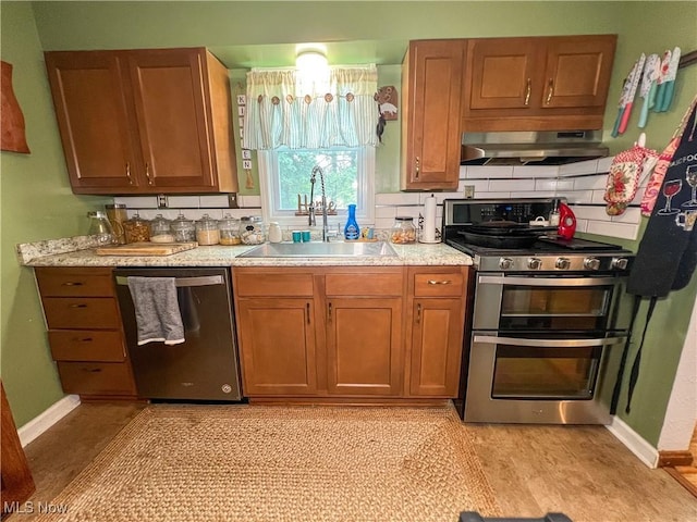 627 Elson St, East Liverpool, OH 43920 - kitchen featuring stainless steel appliances, ventilation hood, light countertops, brown cabinets, and tasteful backsplash
