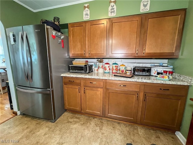 627 Elson St, East Liverpool, OH 43920 - kitchen featuring freestanding refrigerator, brown cabinets, ornamental molding, light stone countertops, and decorative backsplash