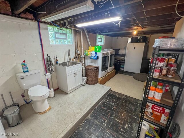 627 Elson St, East Liverpool, OH 43920 - below grade area with washing machine and clothes dryer and tile patterned floors