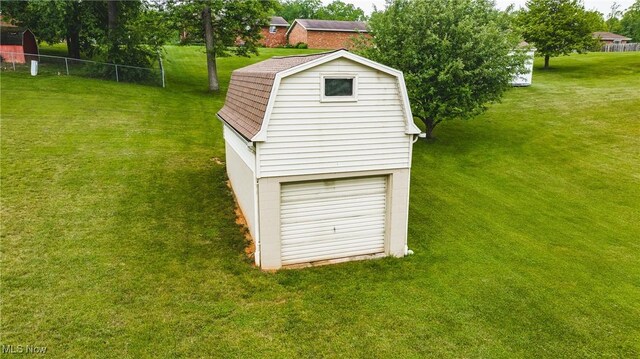488 Maple Dr, Williamstown, WV 26187 - exterior view of a gambrel roof, a downspout, roof with shingles, and gutters