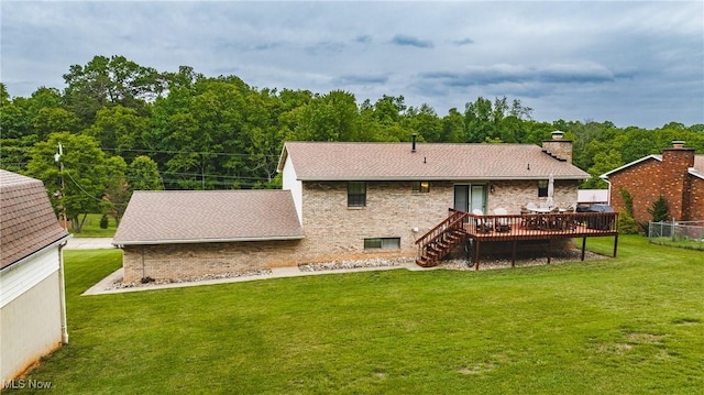 488 Maple Dr, Williamstown, WV 26187 - back of property with a deck, brick siding, a lawn, a chimney, and a shingled roof