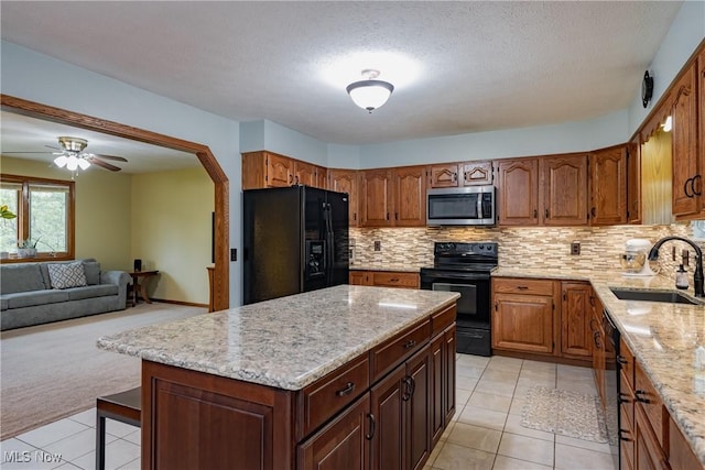 488 Maple Dr, Williamstown, WV 26187 - kitchen with black appliances, a sink, light tile patterned flooring, light stone counters, and a textured ceiling