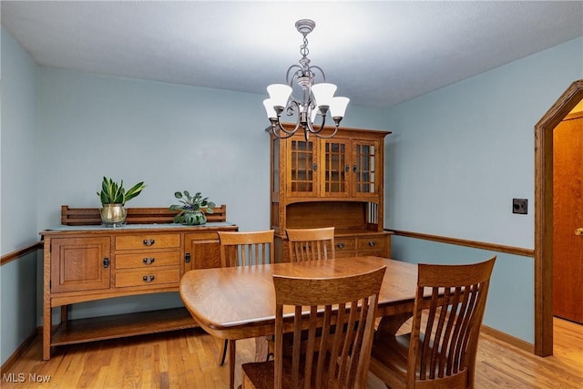 488 Maple Dr, Williamstown, WV 26187 - dining room featuring a chandelier, light wood-style floors, and baseboards
