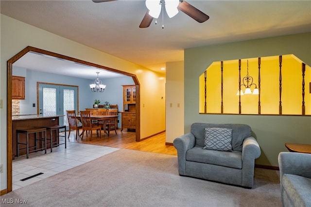 488 Maple Dr, Williamstown, WV 26187 - living room with a chandelier, light colored carpet, a ceiling fan, and baseboards