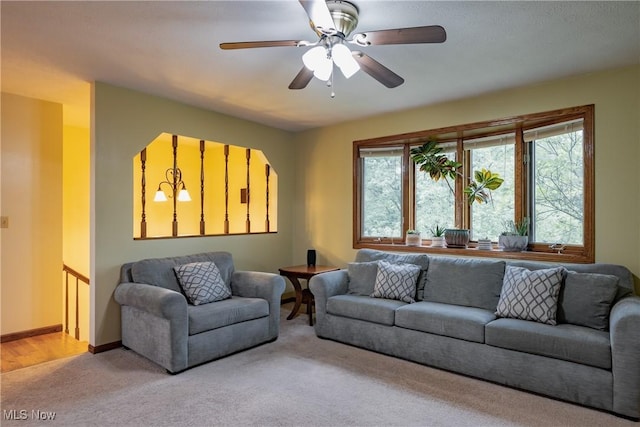488 Maple Dr, Williamstown, WV 26187 - living room featuring light carpet, a ceiling fan, and baseboards