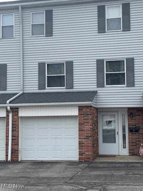 2115 Presidential Pkwy Unit B5, Twinsburg, OH 44087 - view of property with brick siding and a garage