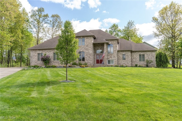 6170 Deer Spring Run, Canfield, OH 44406 - view of front of home featuring brick siding, a front yard, and roof with shingles