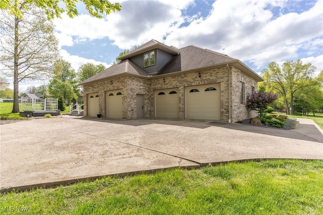 6170 Deer Spring Run, Canfield, OH 44406 - view of property exterior featuring a garage, driveway, and brick siding