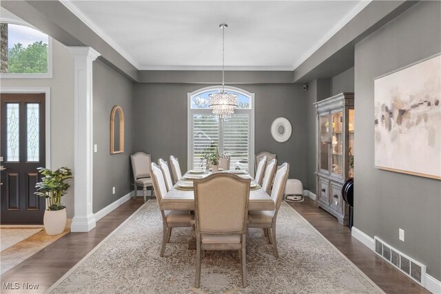6170 Deer Spring Run, Canfield, OH 44406 - dining area with plenty of natural light, a chandelier, dark wood-type flooring, and crown molding