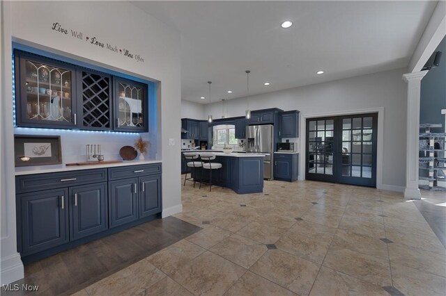 6170 Deer Spring Run, Canfield, OH 44406 - kitchen with appliances with stainless steel finishes, light countertops, ornate columns, glass insert cabinets, and recessed lighting