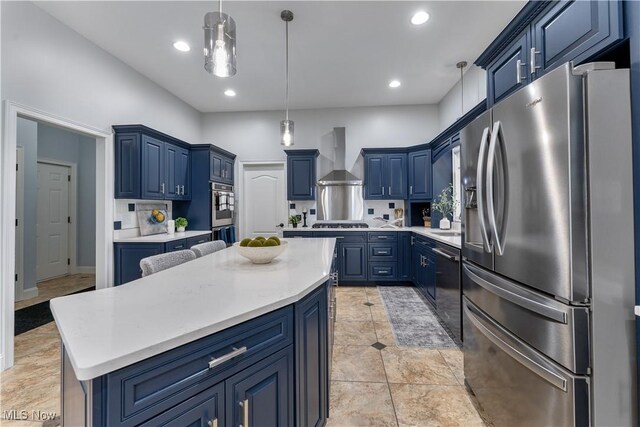 6170 Deer Spring Run, Canfield, OH 44406 - kitchen with stainless steel appliances, blue cabinetry, wall chimney exhaust hood, recessed lighting, and light countertops