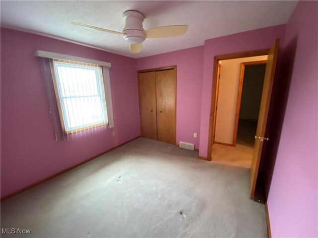 6234 W 54th St, Parma, OH 44129 - unfurnished bedroom featuring light colored carpet, a closet, baseboards, and a ceiling fan