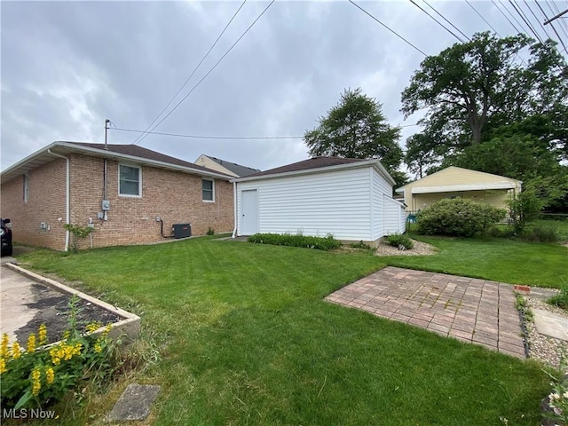 6234 W 54th St, Parma, OH 44129 - back of house with a lawn, a patio area, brick siding, and central AC unit