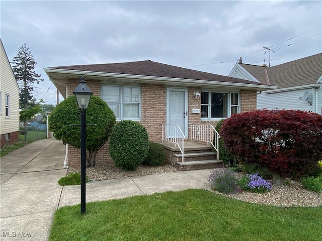 6234 W 54th St, Parma, OH 44129 - bungalow-style home with brick siding and roof with shingles