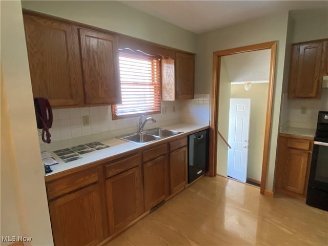 6234 W 54th St, Parma, OH 44129 - kitchen with stove, a sink, dishwasher, and brown cabinets